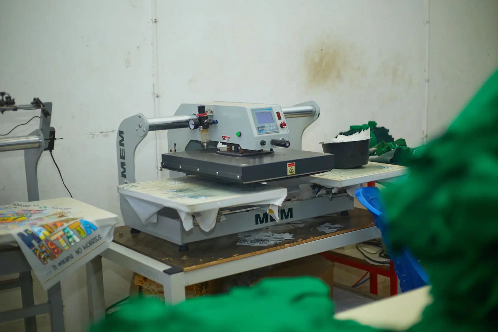Heat press in the decoration room at Swahili Knits