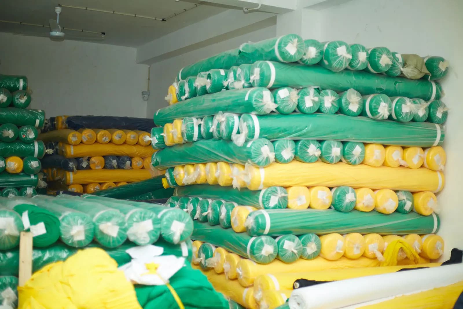 Rolls of knitted fabric in green and yellow