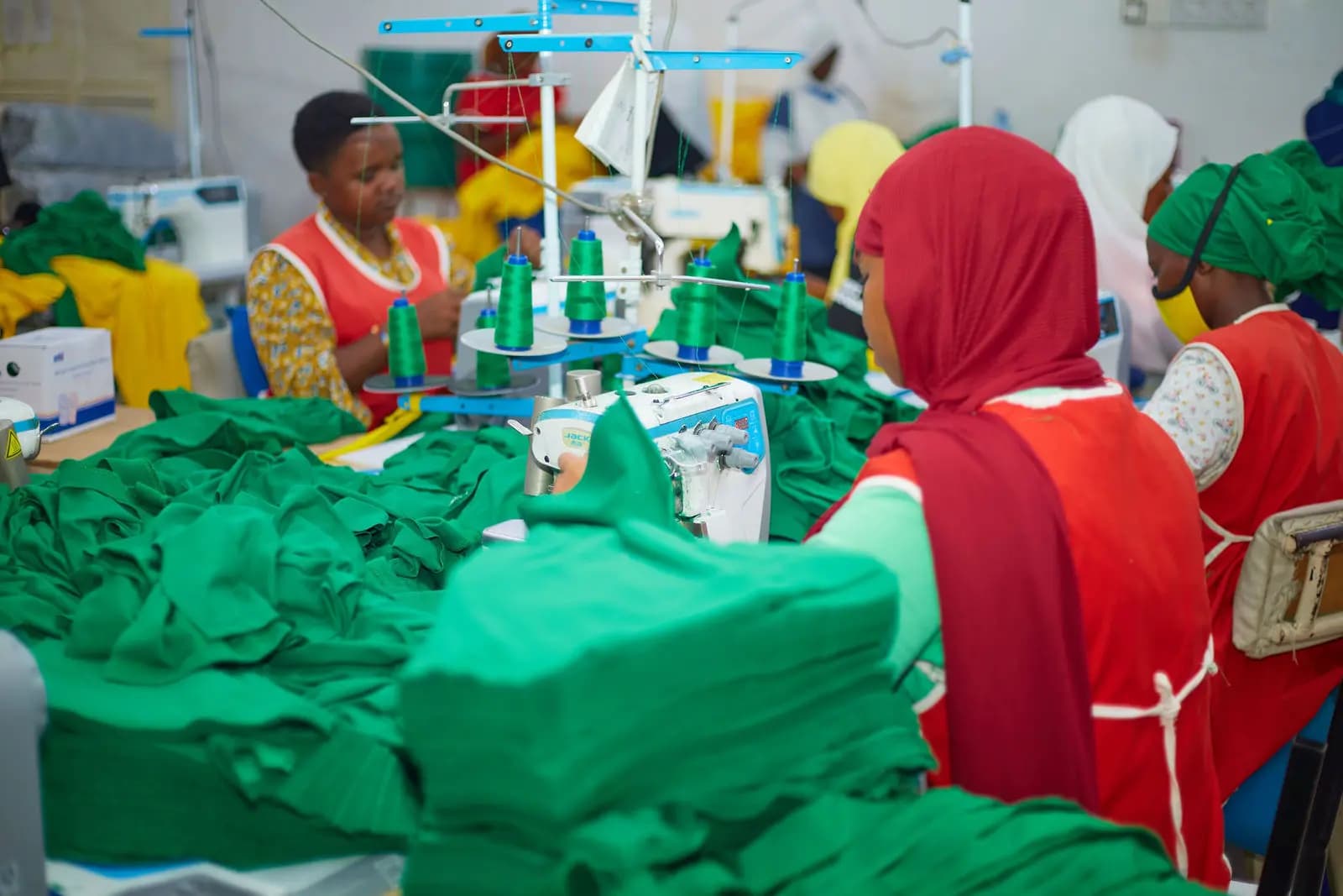 Women operating industrial sewing machines on the production line